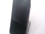 a cell phone that is sitting on top of a stand