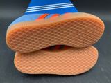 two pairs of shoes are stacked on top of each other on a black surface