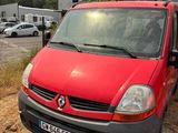 a red van that is parked in the dirt