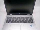 an open laptop computer sitting on top of a white table