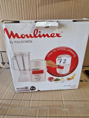 packaging of a blender sitting on top of a cardboard box on a table