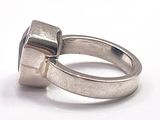 a silver ring with a blue stone in it