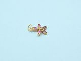 a gold plated dragonfly charm with pink crystals on a blue background