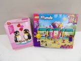 two lego friends figures are sitting next to each other on a table