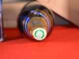 a bottle of wine sitting on a table next to a bottle of wine