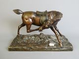 bronze statue of a horse with a saddle on it ' s back