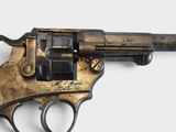 an old gun that is on display on a white surface