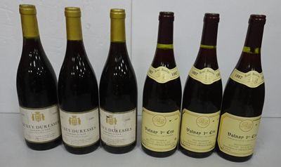 six bottles of wine are lined up in a row on a table