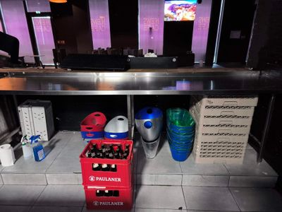 bottles of beer are lined up on a counter in a restaurant
