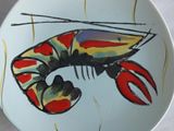a plate with a lobster and a fork on it