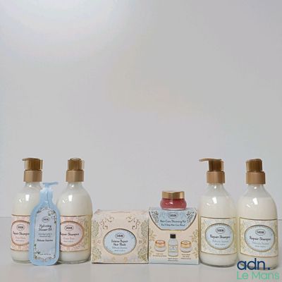 bottles of soap and lotion sitting on a table next to a box of soap