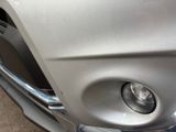 a close up of a car ' s headlight and front bumper