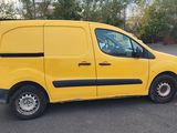 the yellow van is parked in the parking lot next to a white van