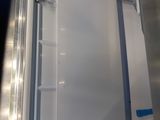 a white refrigerator that is open on the side of the truck