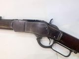 a close up of a gun on a table with a white background