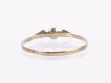 a close up of a gold ring with a diamond in the middle