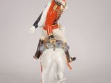 a figurine of a man riding on a horse