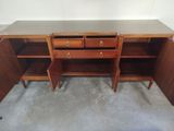 a wooden desk with two drawers and a shelf on top