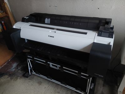 a large printer sitting on top of a stand in a room