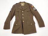 an old military jacket with patches on the sleeves and shoulder