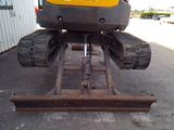 an image of a construction vehicle parked in a parking lot