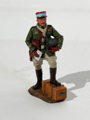 a figurine of a soldier standing on a box