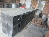 a black refrigerator sitting in the middle of a room