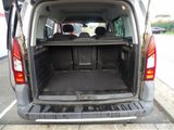 the back of a van with its trunk open in a parking lot