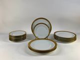 a set of six plates with gold rims on a white background