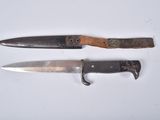 two knives that are sitting next to each other on a table