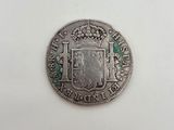 une pièce d'argent sur laquelle figurent des armoiries