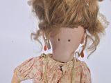 a doll that is wearing a dress and a necklace