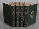 three books are stacked on top of each other on a table