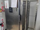 a commercial kitchen with stainless steel appliances and a refrigerator