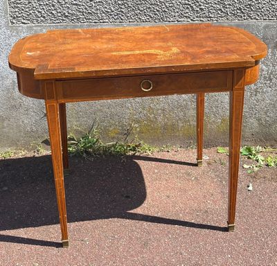 a small wooden table with a drawer on top of it