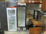a refrigerator that is sitting next to a table in a room