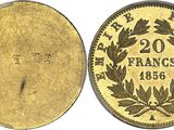 a close up of four different types of coins on a white background