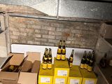 many boxes of beer sitting on the floor next to a stove