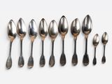 six spoons and two spoons are lined up in a row