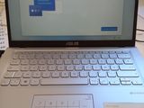 un ordinateur portable posé sur un bureau, avec un clavier