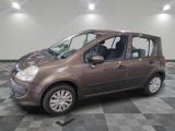 a picture of a small brown car parked in a garage