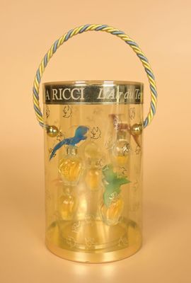 a glass container with a bird on it on a table