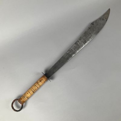 a close up of a knife with a wooden handle on a white surface