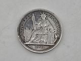 a silver coin with a statue of liberty on it
