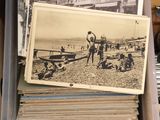 a plastic container filled with old photos on the desk