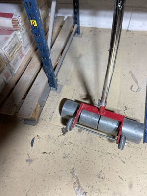 a picture of a pipe clamp on the floor next to a pallet