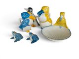 three figurines that are sitting on a white surface