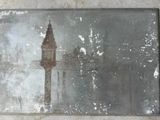 a painting of a clock tower on the wall
