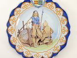 a plate with a picture of a man riding a horse