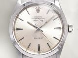 a silver watch with roman numerals on the face